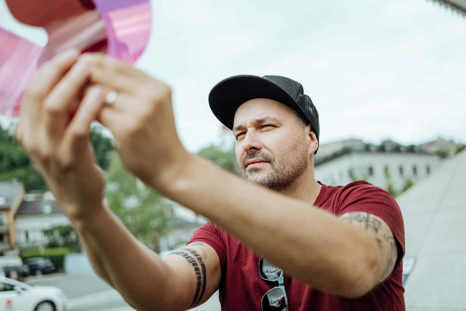 Man holds contrast-enhancing Zeiss lenses up to the light and checks their quality